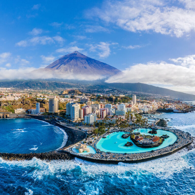 Aerial view with Puerto de la Cruz, in background Teide volcano, Tenerife island, Spain